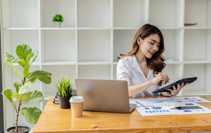Woman using multiple devices at work