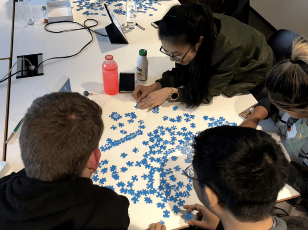 Mobile Mentor Employees Doing Puzzle