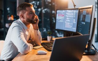 IT person in office with multiple screens