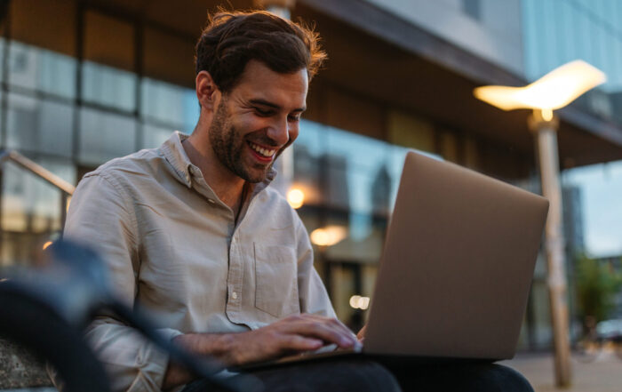 Businessman sitting on the bench with laptop.