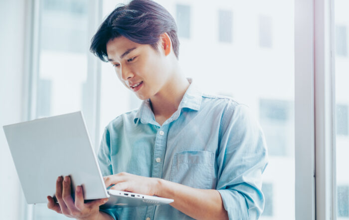 man on laptop migrating from CrowdStrike to Defender