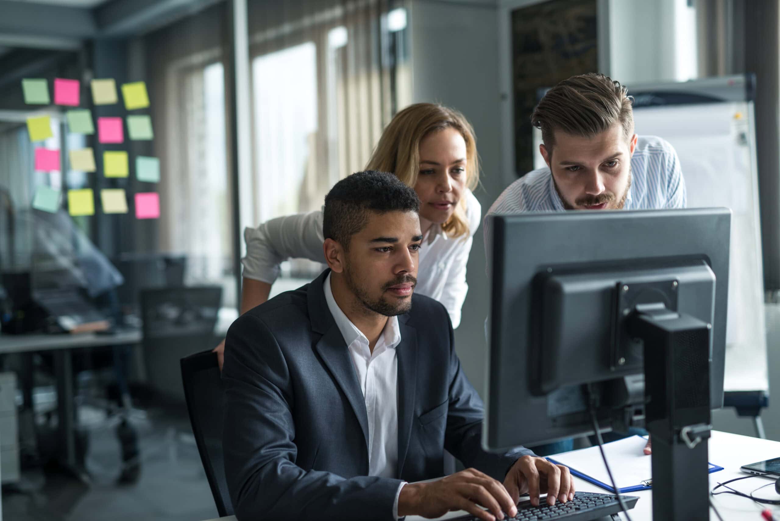 businessman working on a computer with colleagues