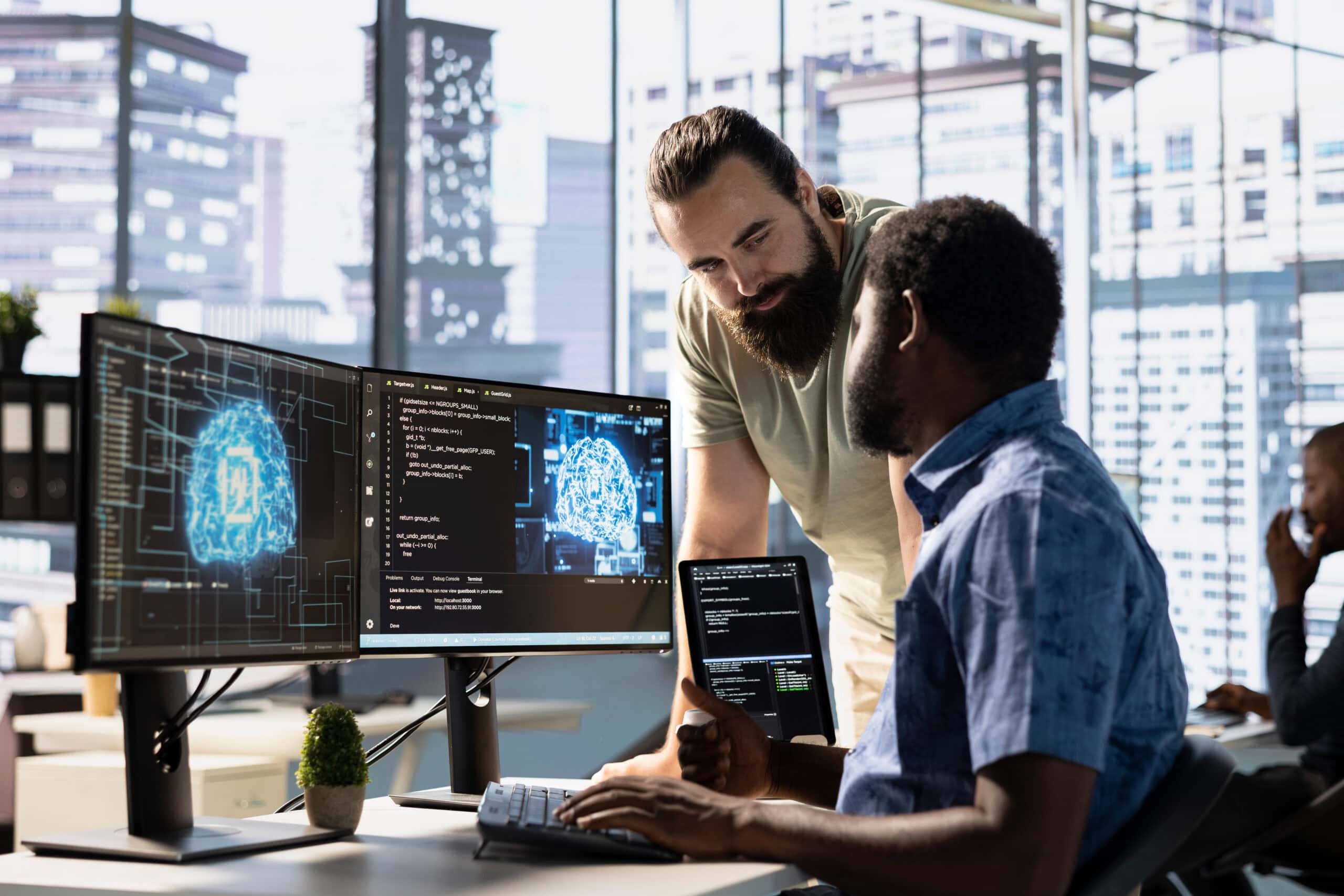 IT staff members testing and deploying artificial intelligence programs and systems. Team of computer scientists checking AI code, sitting at desk chair in office, doing brainstorming
